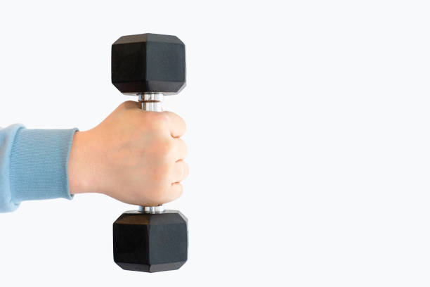istock Male hand holding an iron black dumbbell on white background, copy space. 1461196942