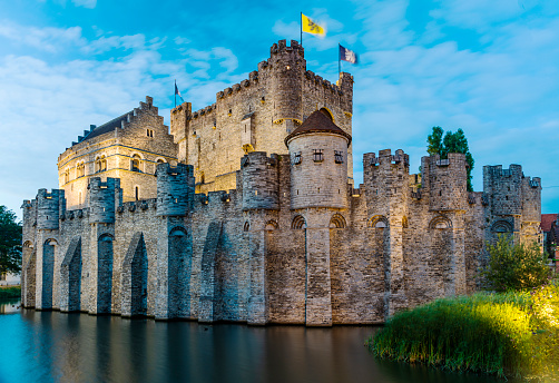 Ghent, Belgium - July 7, 2022: Gravensteen Castle in central Ghent, Belgium lit up in the early evening.