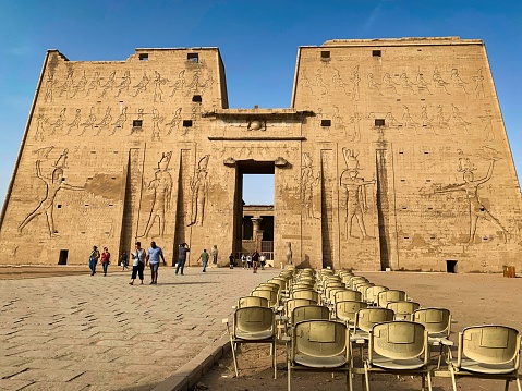 Edfu, Egypt: November 22gy,2022- A Tourist walking towards the Edfu Temple. Egypt. River Nile in the city of Edfu near Aswan, Greco-Roman construction, dedicated to Horus