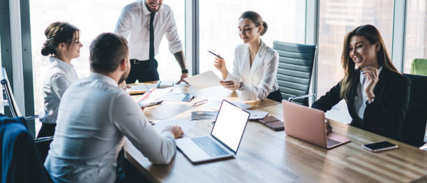 istock Manager making report report to colleagues on meeting in office 1461198497
