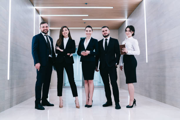 istock Merry coworkers standing in bright corridor 1461198633