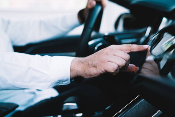 istock Iot system using during automotive steering in contemporary car, man driver checking location direction on automobile technology touching dashboard display for tracking gps on head up cockpit 1461202867