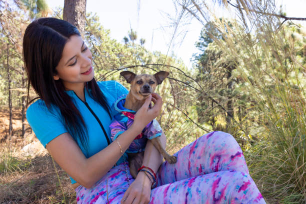 Woman cuddling her puppy