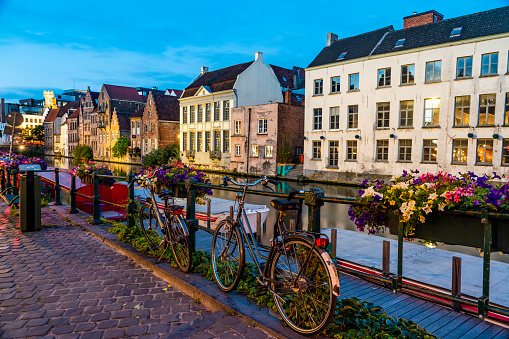 Bikes and flowers along the canal in Ghent, Belgium in the early evening.