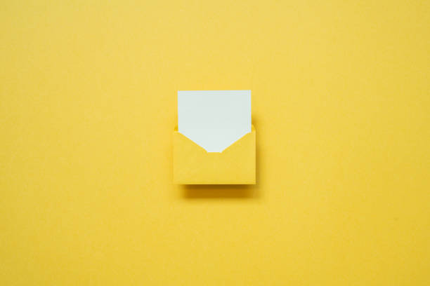 istock Yellow envelope with white blank card on yellow background. top view, copy space, minimalism 1461214944