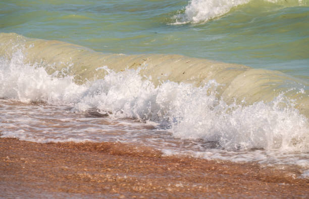 Waves breaking against the beach in Sancti Petri, Cadiz province, Spain