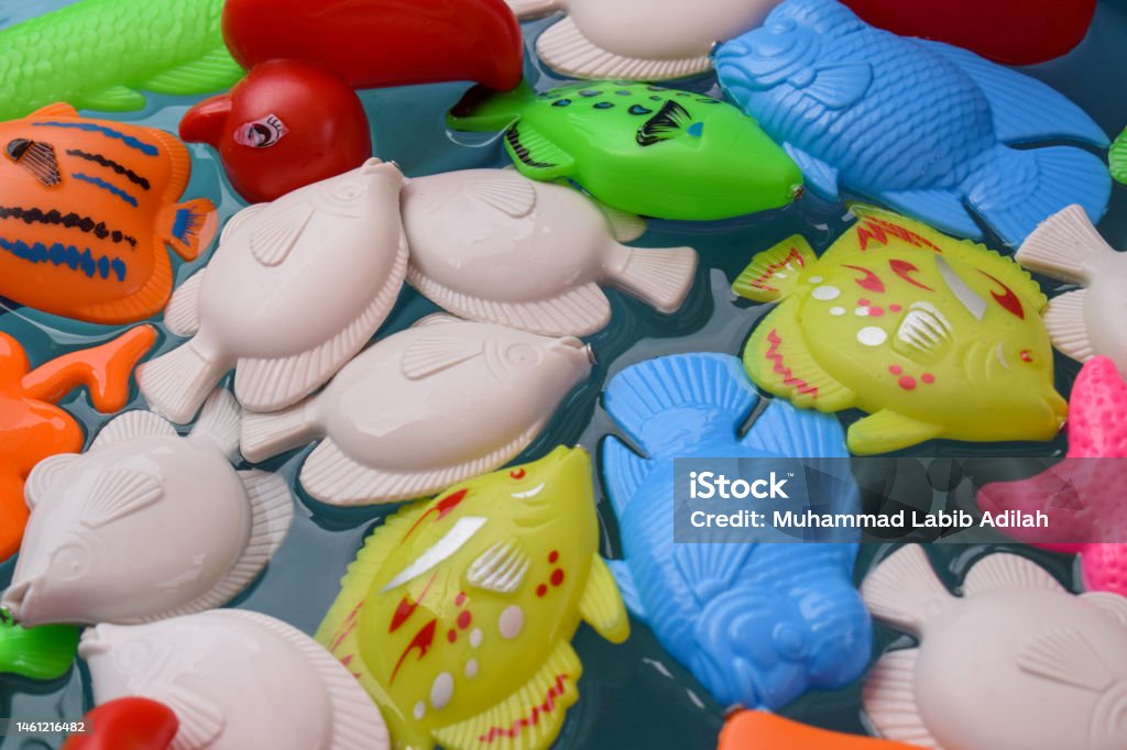 Fishing In The Paddling Pool Childrens Toys In The Pool Toy Fish Fishing  Rod Stock Photo - Download Image Now - iStock