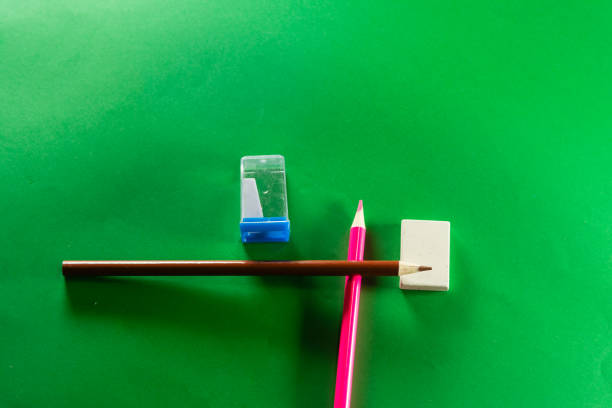 White sharpened pencil and shavings with sharpener on white background