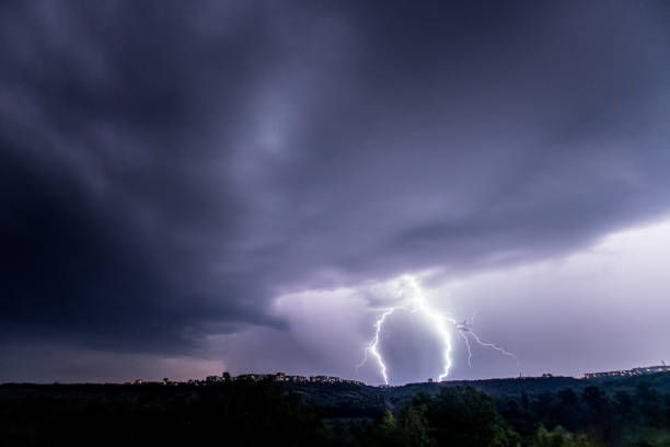 istock Beautiful thunderstorm with clouds and lightning over the night city 1461220754