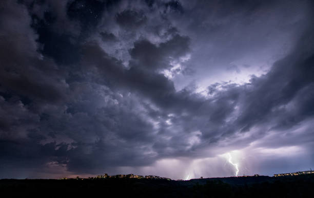 istock Beautiful thunderstorm with clouds and lightning over the night city 1461220772