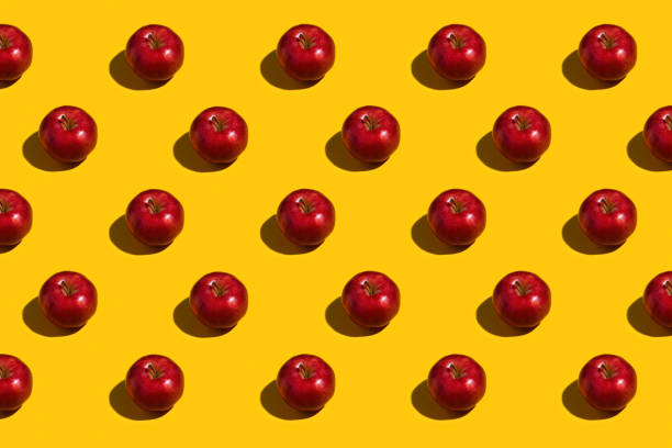 istock Bright red apples on yellow background 1461222861