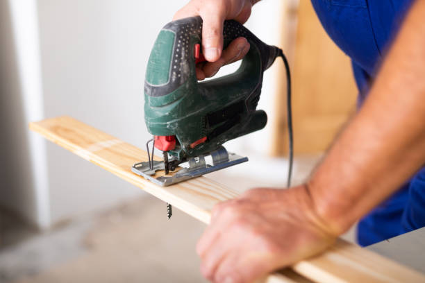 istock Work with an electric jigsaw - cutting wooden board close-up 1461228988