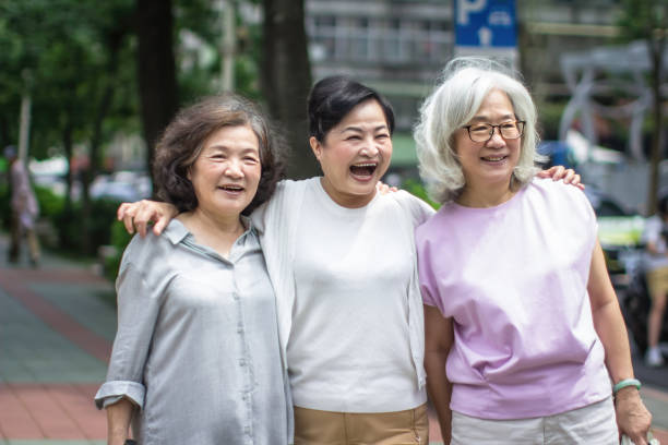 istock Elderly Friendship: Three Old Ladies Walking Hand in Hand 1461229718