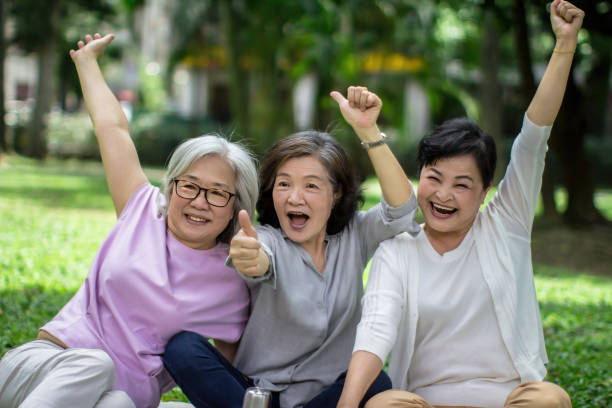 Three energetic senior women relaxing in the park