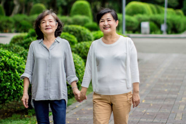 istock Two ladies holding hand walk together 1461230200