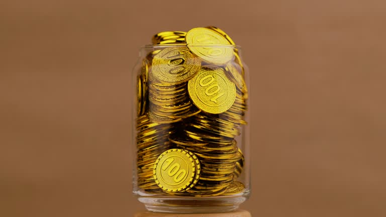 coin in glass jar Silver and gold coins