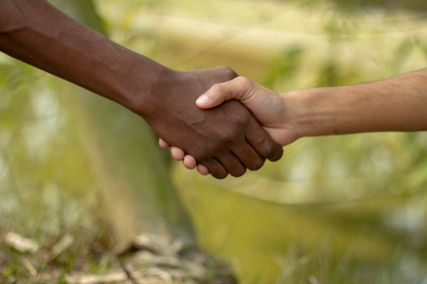 istock there is two hands a black and a white hand meet one another hand and the background is blurred 1461236392