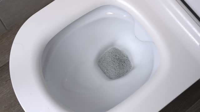 Toilet. Water flushes toilet. Flow of water is clearly visible