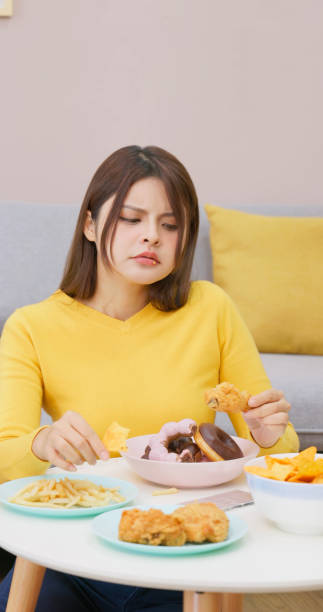 istock Asian girl overeating 1461242763