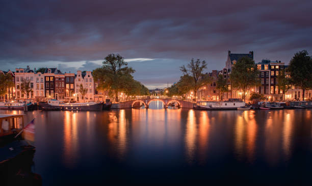 istock Amsterdam Canals with bridge and dutch houses, Netherlands 1461248583
