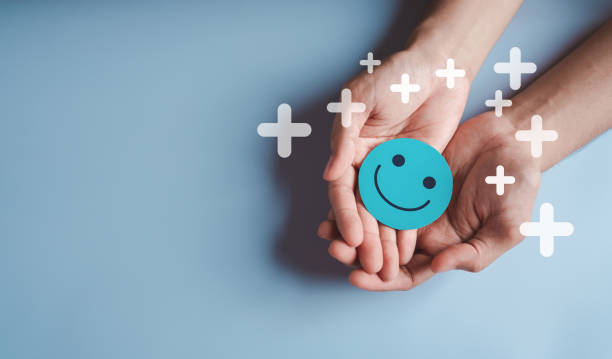 istock Hands holding green happy smile face, good feedback rating, positive customer review, experience, satisfaction survey, smiley mental health, child wellness, world mental health day on green background 1461248962