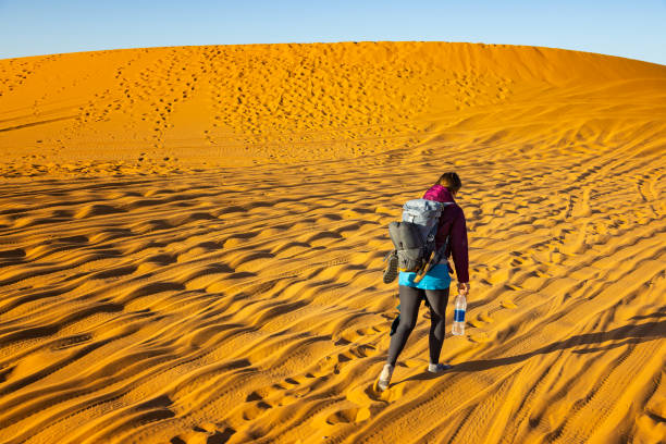 kuvapankkikuvat ja rojaltivapaat kuvat aiheesta naisturisti kävelemässä autiomaassa, merzouga, erg chebbi, sahara, marokko - sand mountain