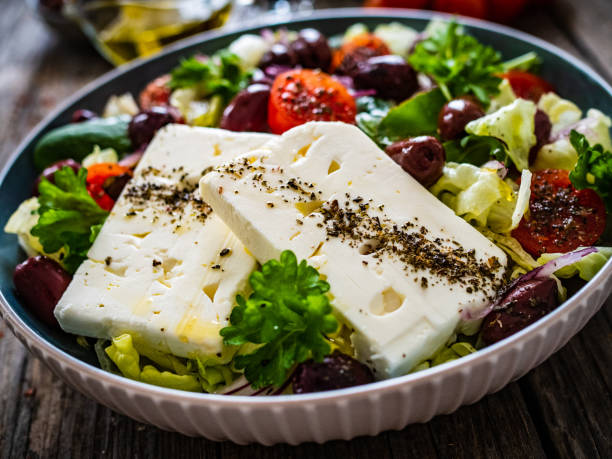 istock Feta cheese salad on wooden table 1461256140