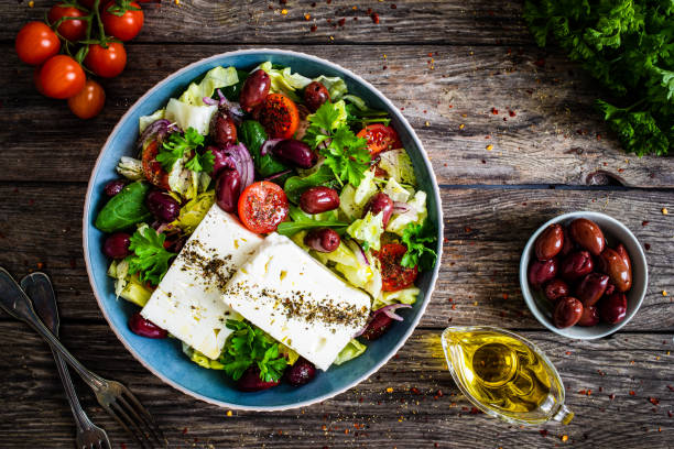 Feta cheese salad on wooden table Feta cheese salad on wooden table mediterranean food stock pictures, royalty-free photos & images