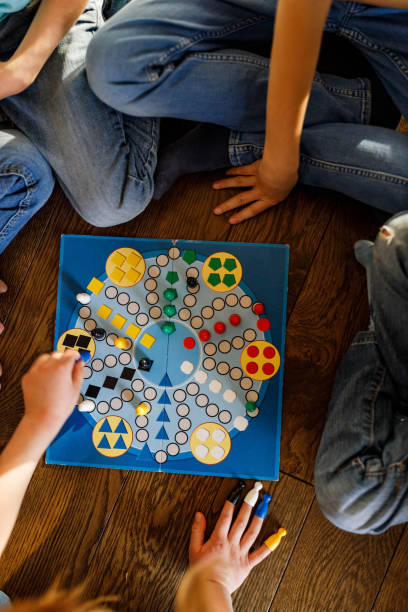 istock Above view of kids playing ludo game. 1461258598