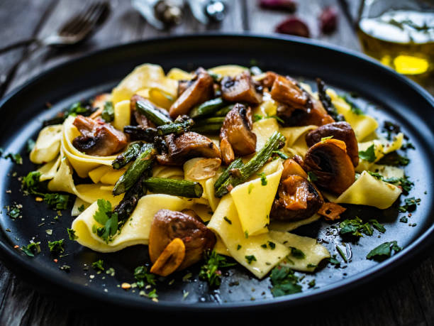 istock Pasta with pesto sauce on wooden background 1461259185