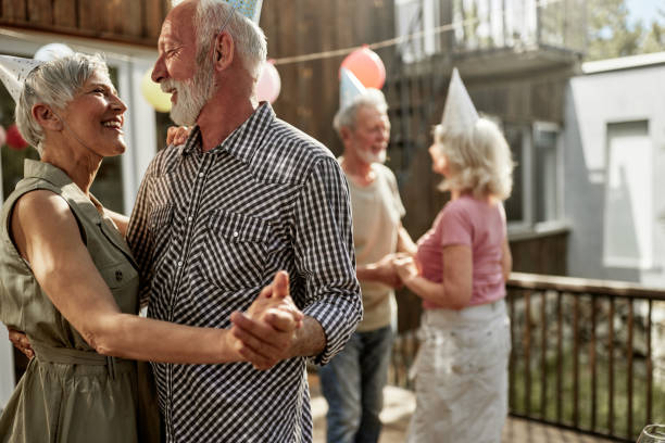 istock Happy senior couples dancing during a Birthday party on a terrace. 1461261133