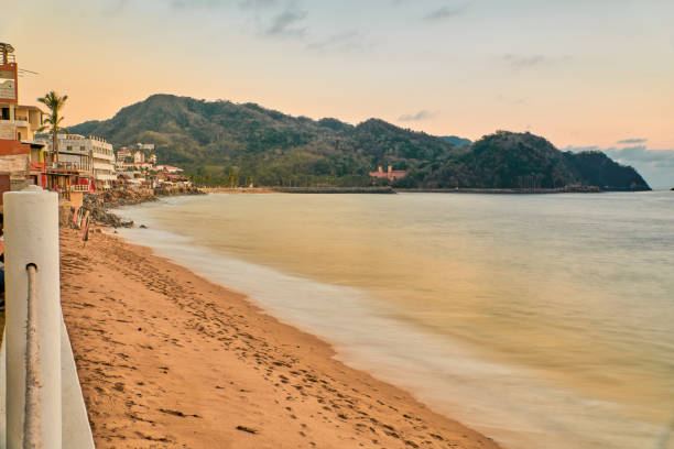 istock sunset on the beach and the sun is setting on the horizon 1461261370