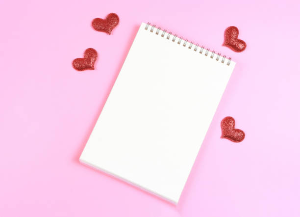 istock flat lay of opened  notebook with red glitter hearts on pink background with copy space. Love, Valentine's day, memory. 1461264081
