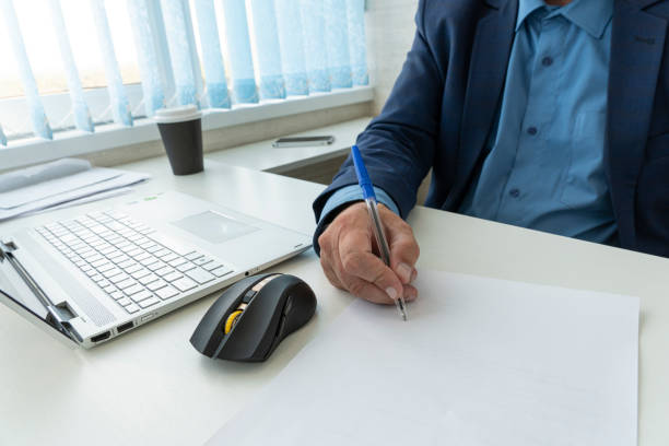 istock Businessman in elegant suit working with documents sign up contract, business plan sitting at desk working, concept of hold blank, empty sheet of white paper. copy space for text 1461267242