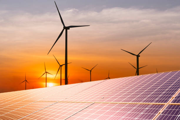 istock wind turbine and a solar panel at sunset.sustainable energy source for smart cities. 1461267773