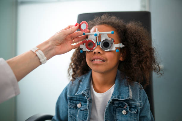 istock Curly Hair Black Child Having an Eye Test with White Mature Optometrist 1461268368