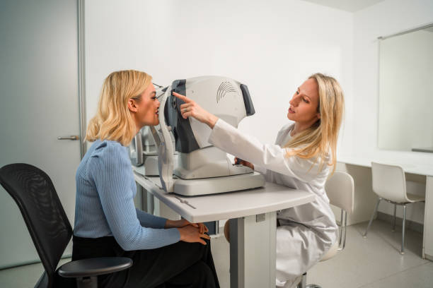 istock Caring Optical Professional Pointing and Instructing White Female Patient 1461268392