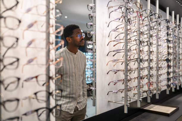 istock Black Beard Male Looking at Mirror and Glasses Options 1461268681