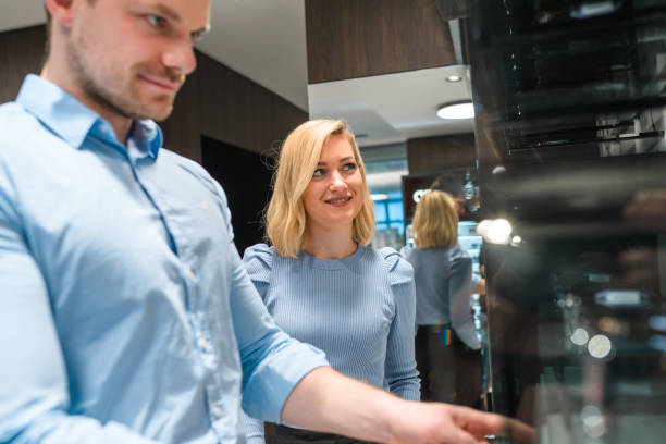 istock Stylish Couple Looking at Products Inside Eyeglasses Store 1461268715