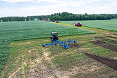 large agricultural machine cultivates the land. The view from the top. Plowing land for planting crops. photos from the bird's eye view with quadcopter