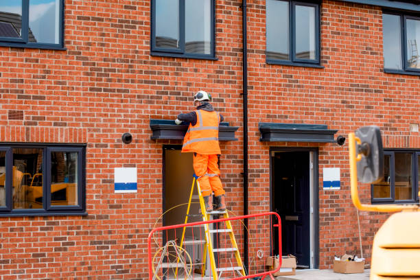 construction site builder climbing on the ladder on working on hight - uk scaffolding construction building activity imagens e fotografias de stock