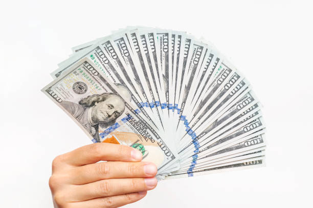 istock Hand with US dollar bills isolated on white background 1461272519