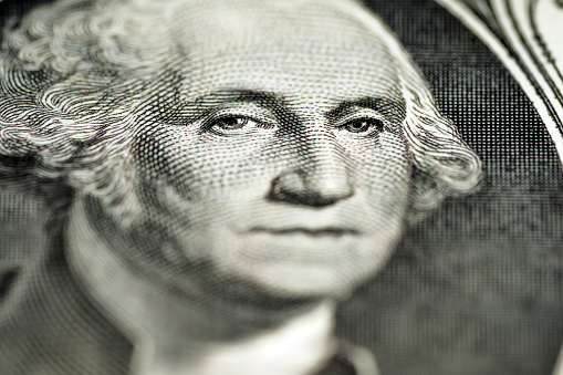 Close up of George Washington on 1 dollar bill.