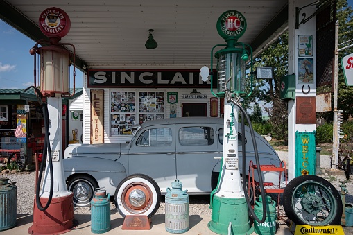 Ash Grove, United States – September 15, 2022: The white, classic Ford Super Deluxe car at the old gas station in the daytime
