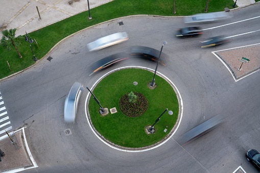 A motion blur of cars driving around a roundabout