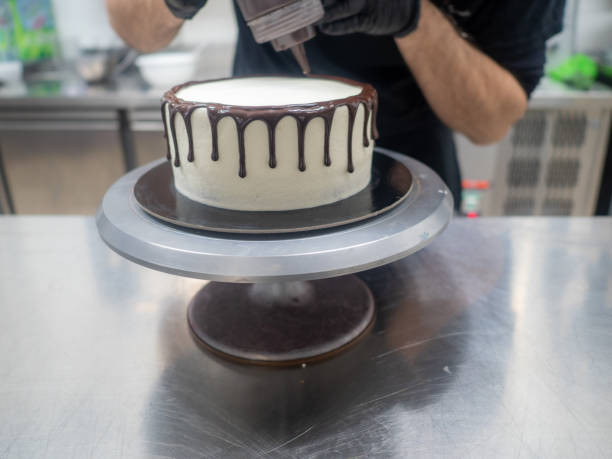 istock cake pastry chef designer decoration a dark chocolate frosted icing white cake with brown dripping with ganache filling 1461277321