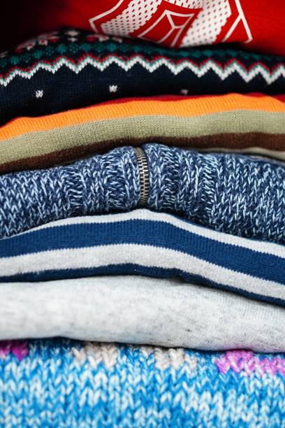 istock Vertical shot of folded sweaters stacked on each other 1461278418