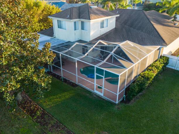 istock Aerial view of pool screen enclosure surrounded by trees 1461280558