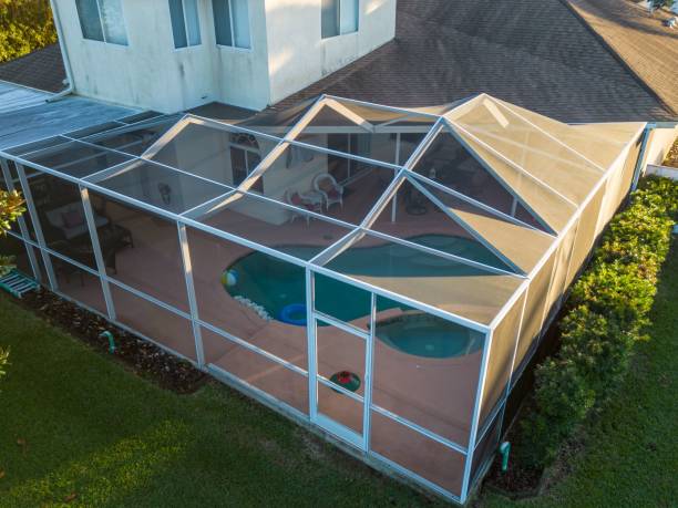 Aerial view of pool screen enclosure surrounded by trees An aerial view of pool screen enclosure surrounded by trees enclosure stock pictures, royalty-free photos & images