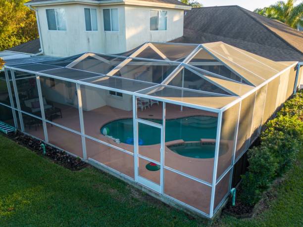 istock Aerial view of pool screen enclosure surrounded by trees 1461280581